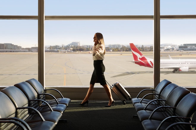 Lady on phone walking through airport