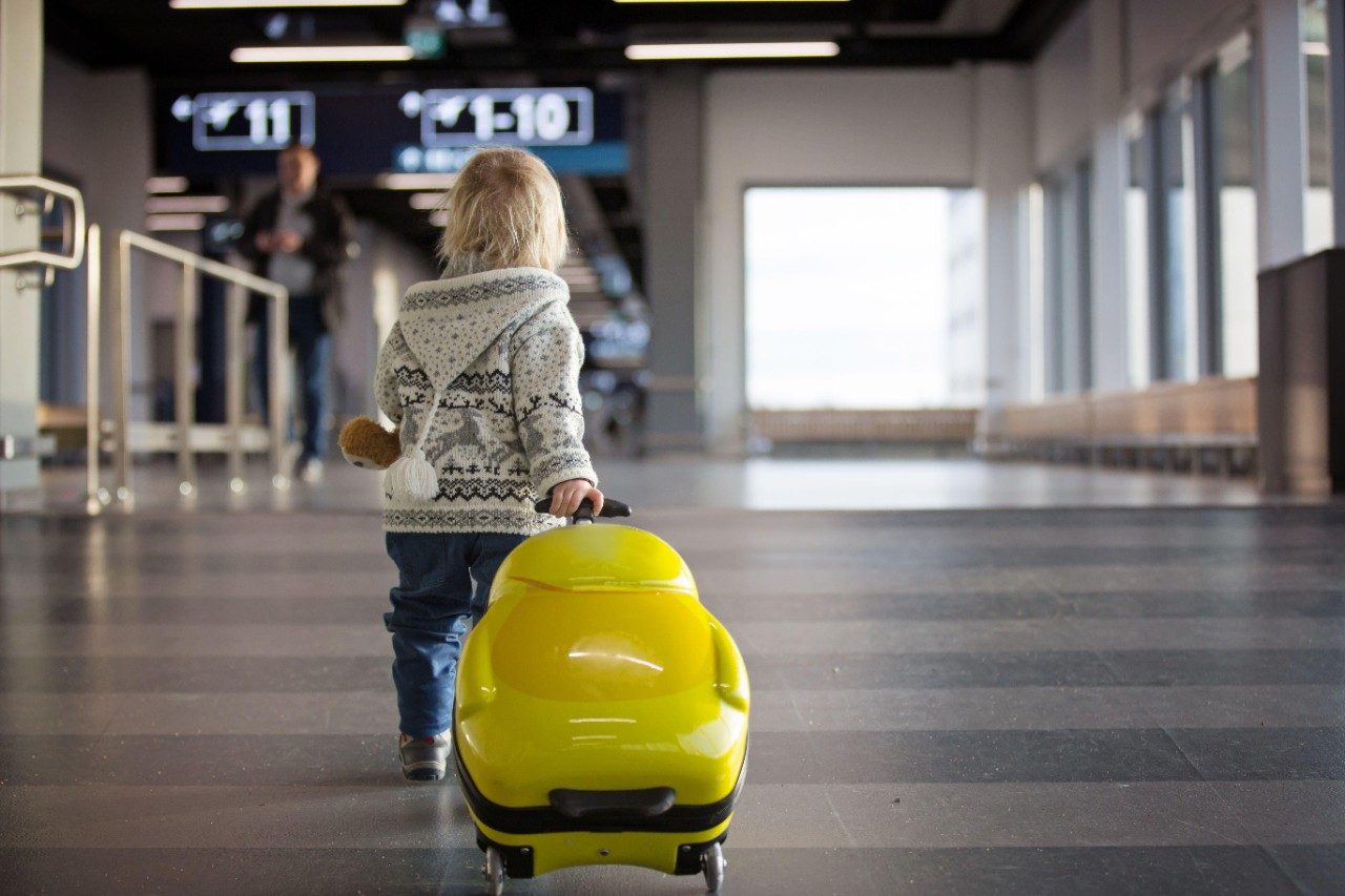 Travelling with Toddlers, child at airport with bumblebee suitcase